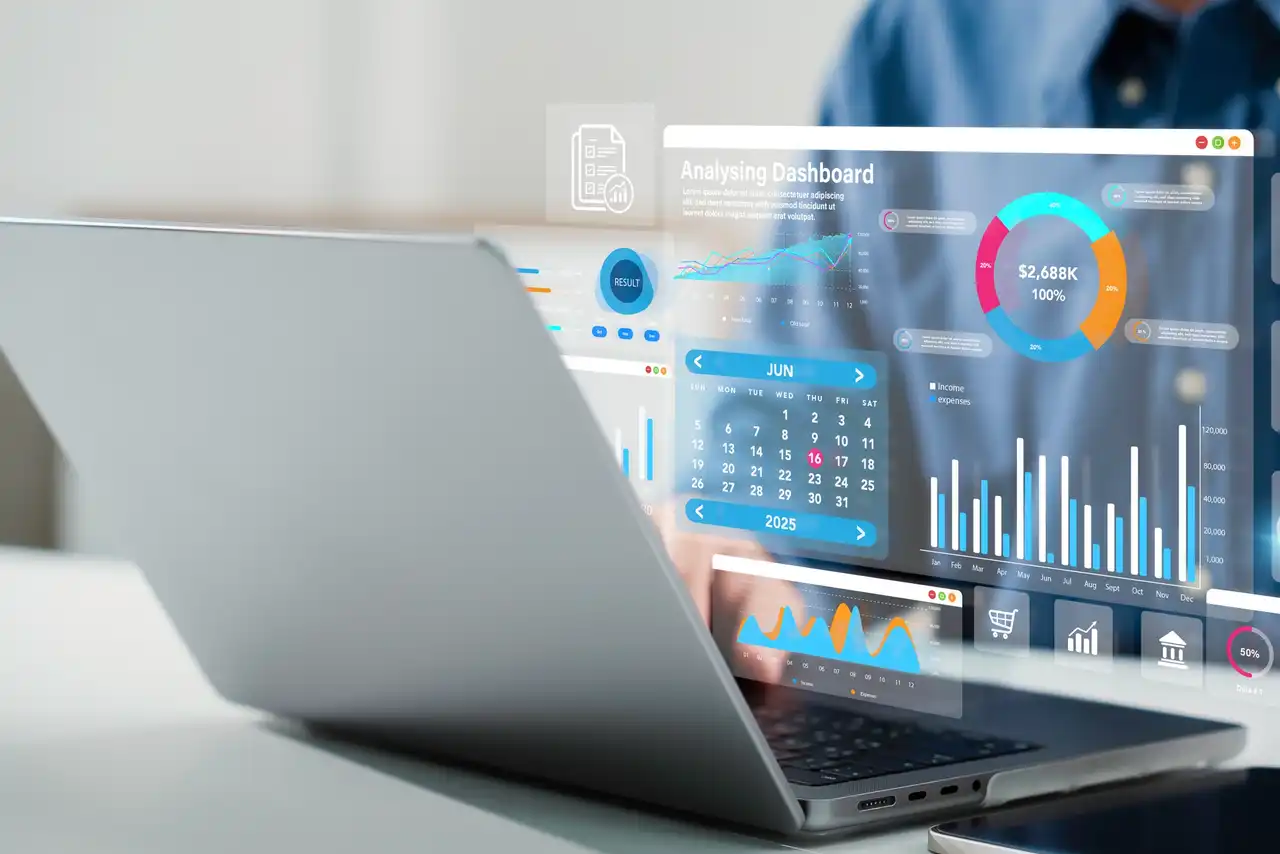 Analytics dashboard visual beside a laptop